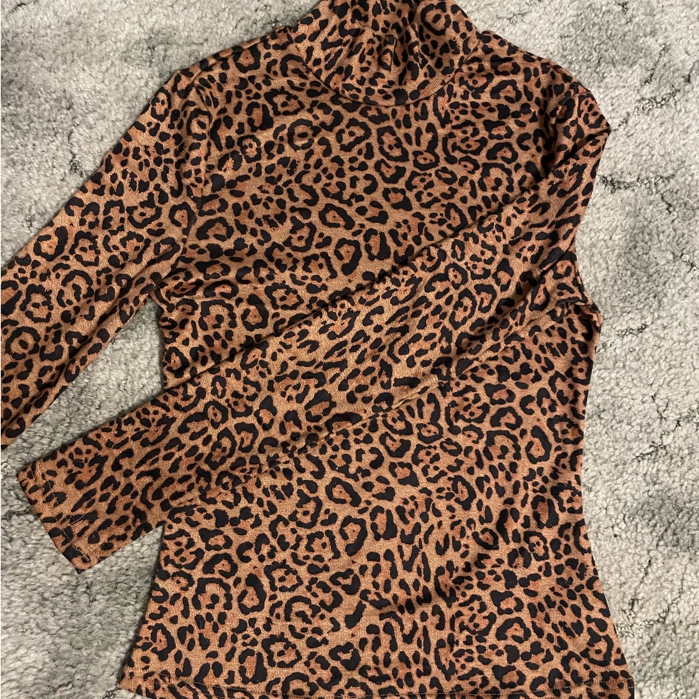 Black and brown cheetah print, tight fitting, long sleeve, turtle neck.